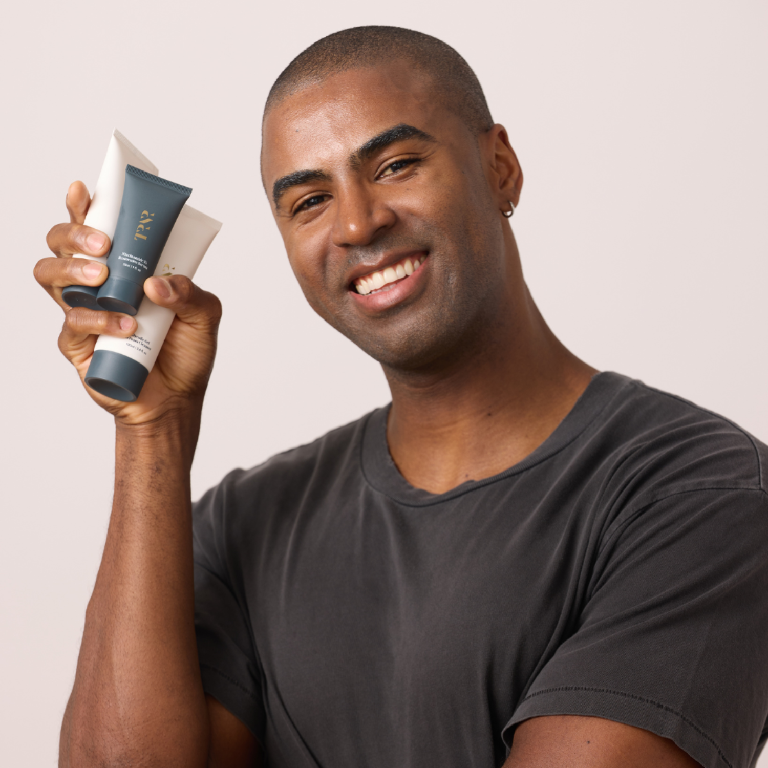 male model holding The TRNR Method Skincare Products, Dermatologist-developed and plant-powered, clean and clinically-effective skincare